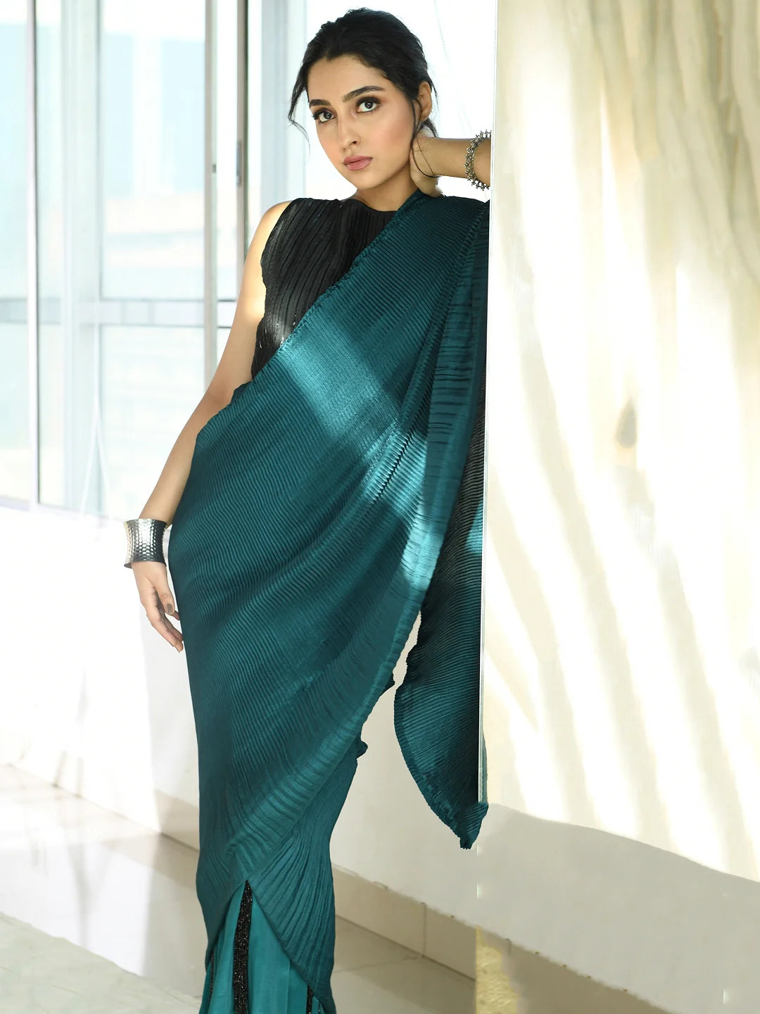 Teal pleated fringe saree with pleated embroidered blouse